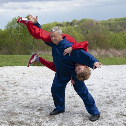 Grandmaster Sangee Tam holding Master Annukka upside down